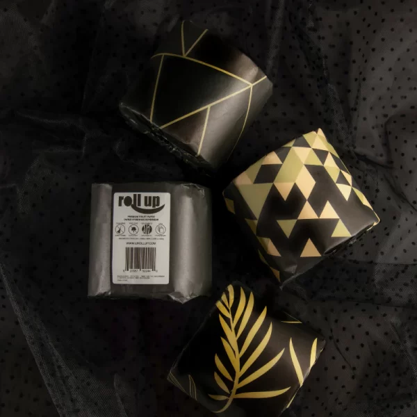 four rolls of tp with black & gold wrapping