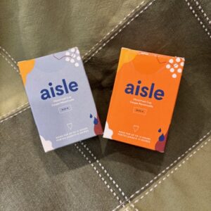 two boxes each holding a different size menstrual cup
