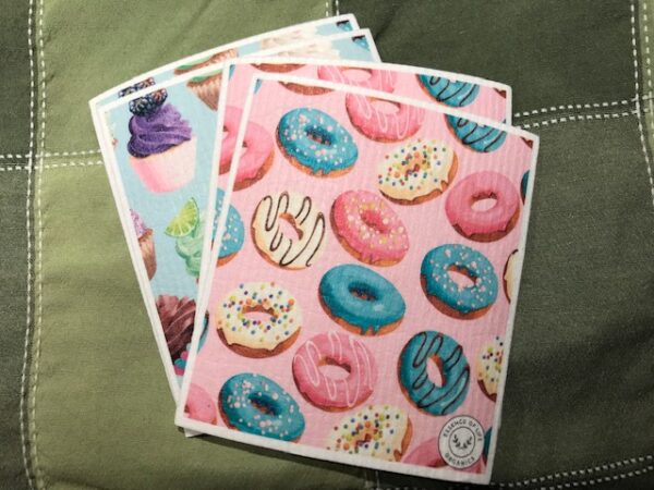 two swedish dish cloths, one with cupcakes, one with donuts