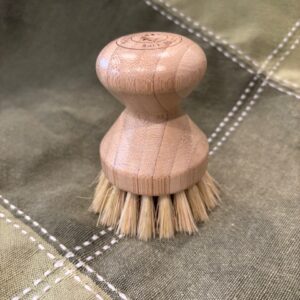 A smooth knob-handled scrub brush